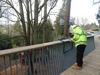 Interpretation being clamped to the balustrade of the walkway