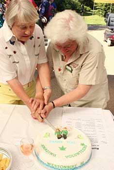 Chloe and Pam, two of our longest serving volunteers, cut the cake Chloe and Pam, two of our longest serving volunteers, cut the cake