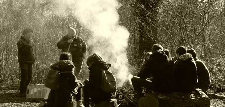 A group of young people around a camp fire