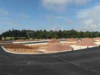 You can see piles of the Forest of Dean 'pink' stone which will be spread and compacted to form the parking bay final surface.