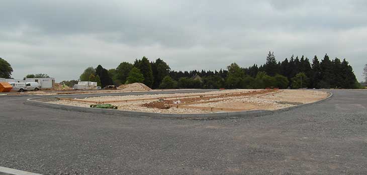Part of the new road with stone parking bays taking shape