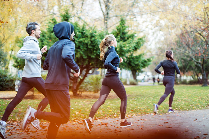 A group of runners on a trail path