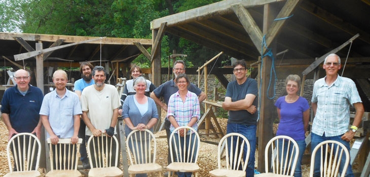 Group of students at Westonbirt Woodworks with their handmade chairs