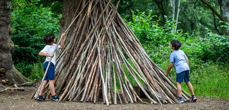 Children creating a natural den