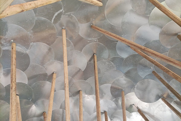 A ceiling made of metal plates and wooden sticks, creating a unique and rustic design.