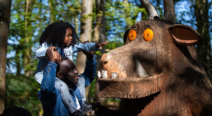 Family exploring the Gruffalo sculptures