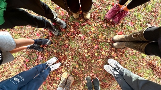 Workshop participants exploring what connection looks like - here by connecting with nature and with each other